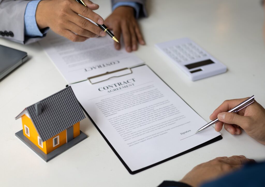 Businessman signing a contract agreement, mortgage, rent, lease, home insurance.
