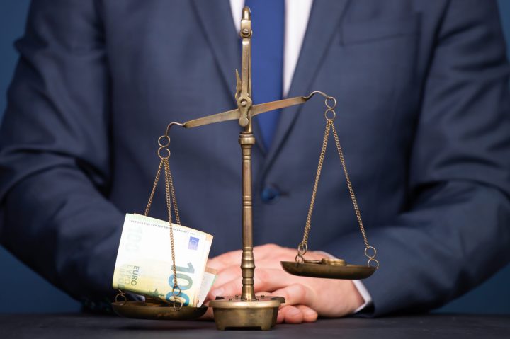 Concept of earning balance with businessman that weighs the money